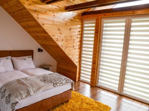 a bedroom with a bed and a wooden wall at RIVER REST - ADULTS ONLY in Świeradów-Zdrój