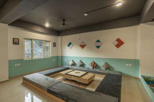 a living room with a couch and a table at Zostel Plus Kareri in Dharamshala