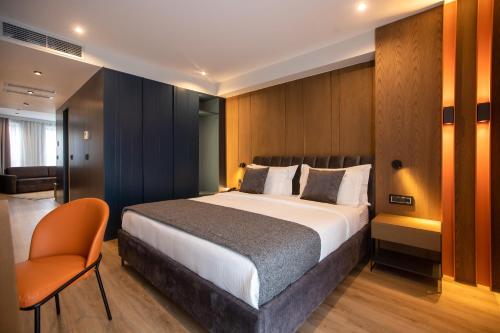 a bedroom with a large bed and a chair at Hotel Elisa Tirana, Affiliated by Meliá in Tirana