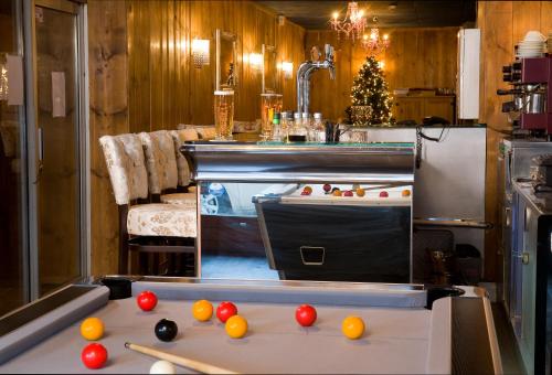 a kitchen with a ping pong table with balls on it at Madame Vacances - Hôtel Courchevel Olympic in Courchevel