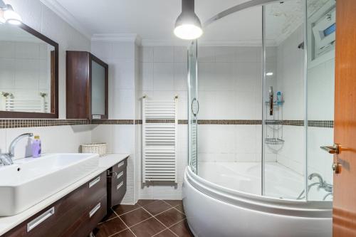 a bathroom with a tub and a sink and a shower at Delightful Flat with Bosphorus View in Kuzguncuk in Istanbul