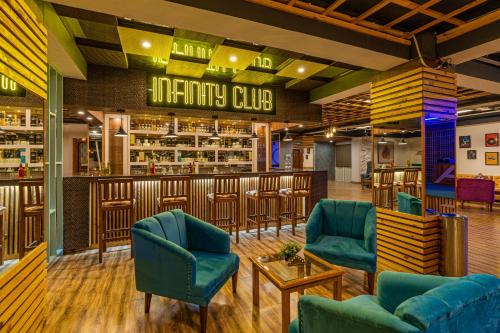 a bar at a restaurant with blue chairs at Zostel Plus Kareri in Dharamshala