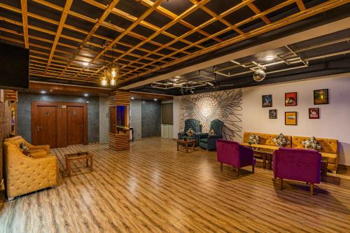 a large living room with a table and chairs at Zostel Plus Kareri in Dharamshala