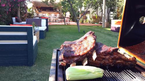 a piece of meat on a grill in a yard at Yucca Alaçatı in Alaçatı