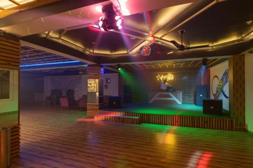 a room with a dance floor with lights on at Zostel Plus Kareri in Dharamshala