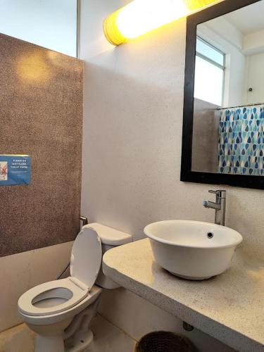 a bathroom with a toilet and a sink at Villa Papillon in Phnom Penh