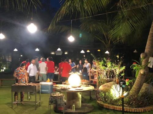 a group of people standing at an event at night at LAGI FARMSTAY in La Gi