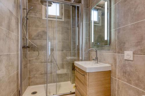 W łazience znajduje się prysznic i umywalka. w obiekcie Bel appartement aménagé de 30m2 w mieście Colombes