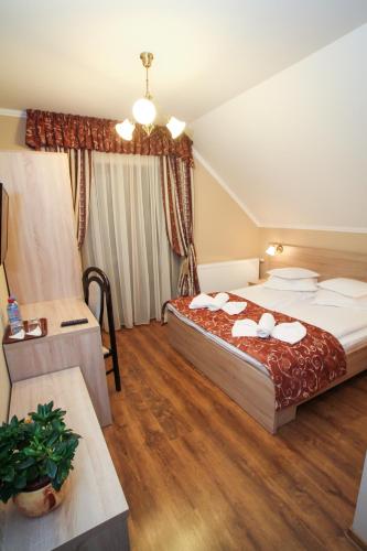 a hotel room with two beds and a table at Németh Resort in Sovata