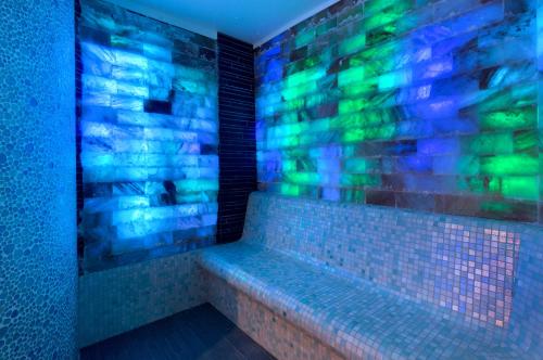 a bathroom with a tub with blue and green lights at Grand Hôtel Thalasso & Spa in Saint-Jean-de-Luz