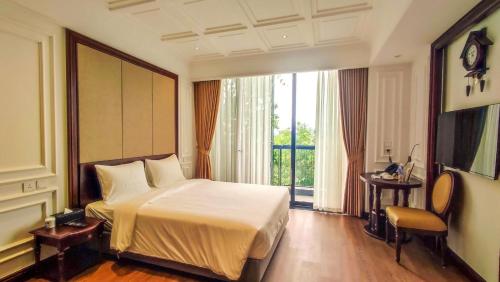 a hotel room with a bed and a large window at A25 Hotel - 18 Nguyễn Hy Quang in Hanoi