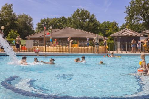 a group of people swimming in a swimming pool at Vakantiepark De Boshoek in Voorthuizen