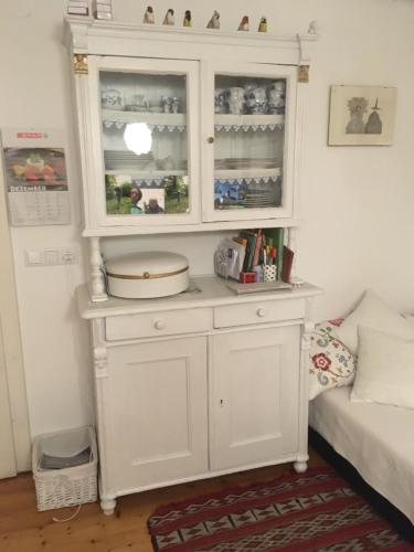 a white hutch in a corner of a room at Ferienhaus Mesnerhaus Steuerberg in Feldkirchen in Kärnten