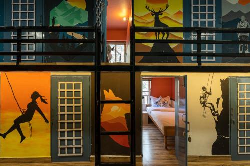 a collage of images of a room with paintings on the walls at Zostel Plus Kareri in Dharamshala