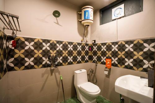 a bathroom with a toilet and a sink at Zostel McLeodganj in McLeod Ganj