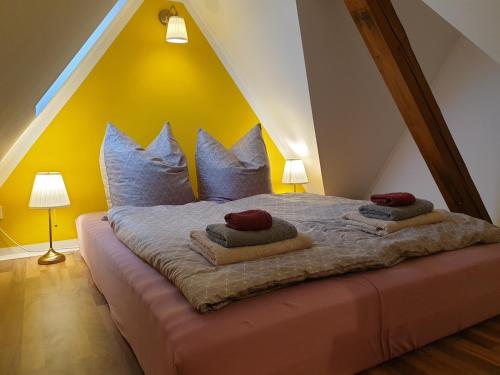 a bedroom with a bed with pillows on it at Ferienhaus Oberlausitz in Cunewalde