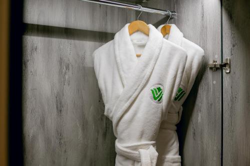 a white hoodie hanging on a wall at Wyndham Garden Baku in Baku