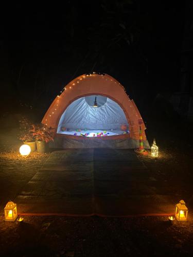 a tent is lit up at night with lights at Citadel Resort in Panchgani