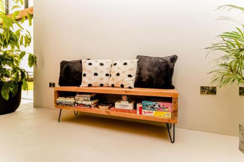a bench with pillows on it in a room at Beautiful Barn Conversion Close To The Broads in Dilham