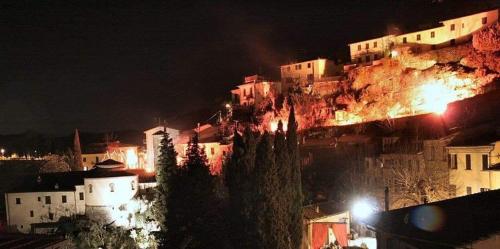 a group of buildings on a mountain at night at La Casa di LiLi in Pontassieve