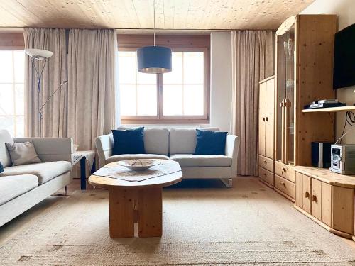 a living room with a couch and a table at Hotel Ducan in Monstein