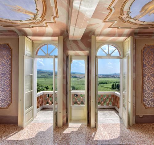 a room with windows and a ceiling with a view at Palazzo Montanari Art & Wine Luxury Apartments in Fumane