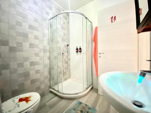 a bathroom with a shower and a toilet and a sink at Central Private En-Suite with Balcony in shared residence in Tal-Pietà