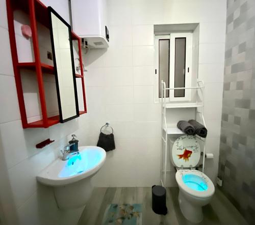 a bathroom with a sink and a toilet and a mirror at Central Private En-Suite with Balcony in shared residence in Tal-Pietà