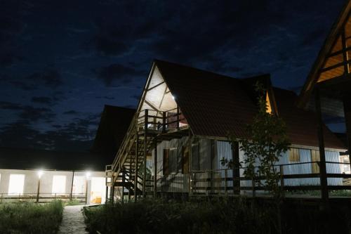 a house at night with its lights on at Armenian Camp in Artanish