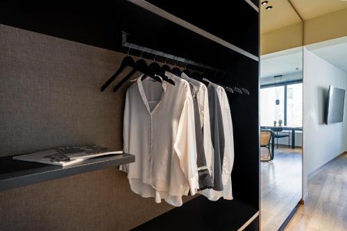 a closet with a shelf with a white shirt on it at Athens Woo Suites in Athens