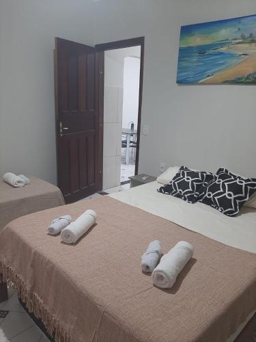 2 camas con toallas enrolladas encima en Apartamento.mutchisma5, en Porto Seguro