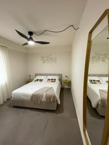 a bedroom with a bed and a ceiling fan at Lucia Holiday Apartments in Lazise