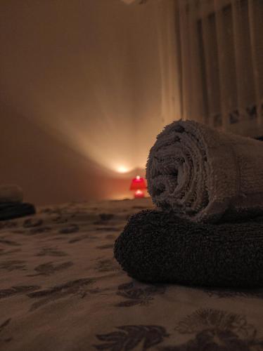 a pile of towels sitting on top of a bed at Apartman Sunshine in Doboj