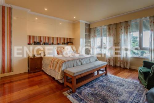 a bedroom with a bed with a bench in it at CASA MEXILLOEIRA in O Grove