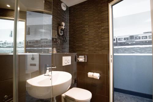 a bathroom with a sink and a toilet at Appia La Fayette in Paris