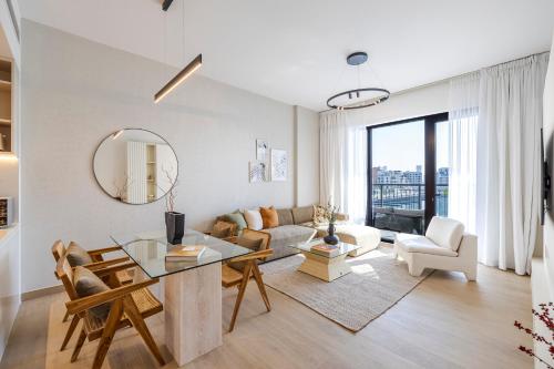 a living room with a couch and a table at 2BR Le Pont B3 Full Sea and Pool View in Dubai
