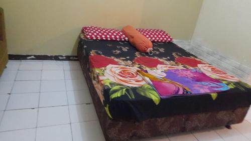 a small bed with a blanket on top of it at Lily's Room in Cibubur
