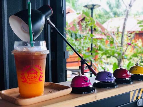a drink sitting on a table next to a tray with a lamp at กอบสุข รีสอร์ท2 k12 in Ban Ton Liang