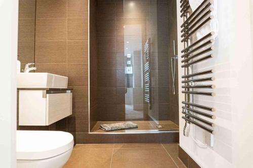 a bathroom with a shower and a toilet and a sink at Luxury 3 Bedroom 3 Bathroom Balcony Apartment - Gunwharf Quays Apartments in Portsmouth