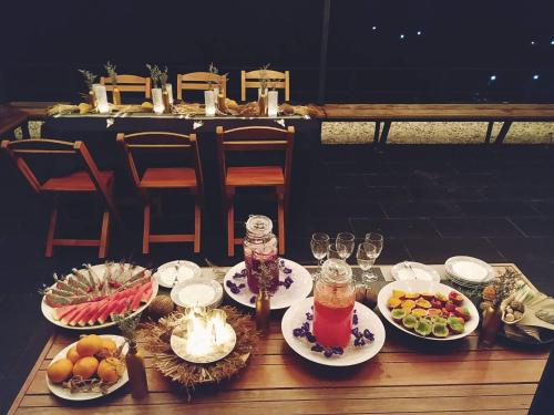 a table with plates of food and drinks on it at Ao Luek Panoramic Pool-SHA Plus in Ao Luk