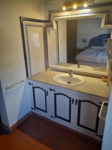 a bathroom with a sink and a mirror and a bed at Navila Numero 2 in Ibiza Town