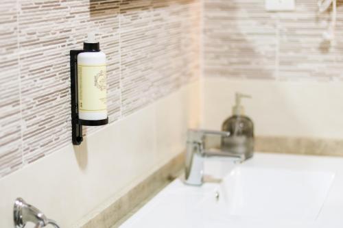 a bathroom with a soap dispenser next to a sink at São Pedro Country House in Campo Maior