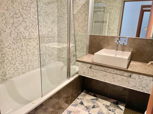 a bathroom with a tub and a sink and a shower at Charming Cascais Apt. in Cascais