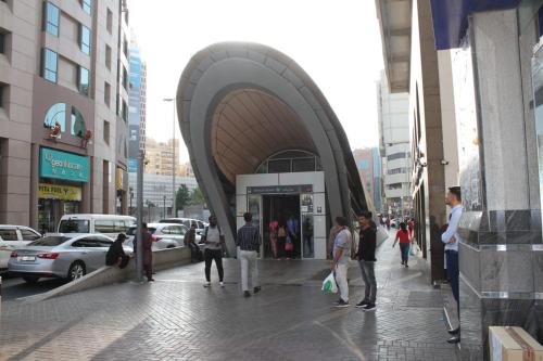 a group of people walking on a sidewalk in a city at Mark Inn Hotel Deira in Dubai
