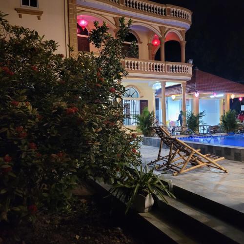 a villa with a swimming pool at night at Tam Coc Mountain Lake Homestay in Ninh Binh