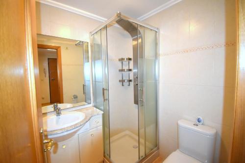 a bathroom with a shower and a toilet and a sink at Apartamento Golden Beach in Jávea