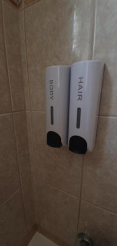 two nintendo wii controllers on the wall of a bathroom at Vasilas Holiday Apartment #2 in Larnaca