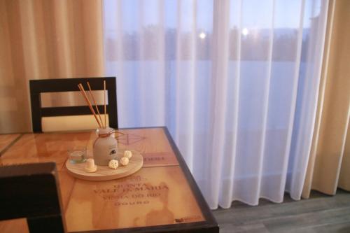 a table with a chair and a plate with chopsticks at São Pedro Country House in Campo Maior