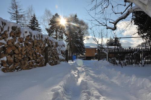 a pile of snow in front of a fence at Forester Apartment Zuberec in Zuberec