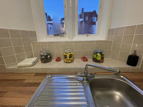 a sink in a kitchen with a window at Gated Stunning Period Studio in Vibrant Bristol in Bristol